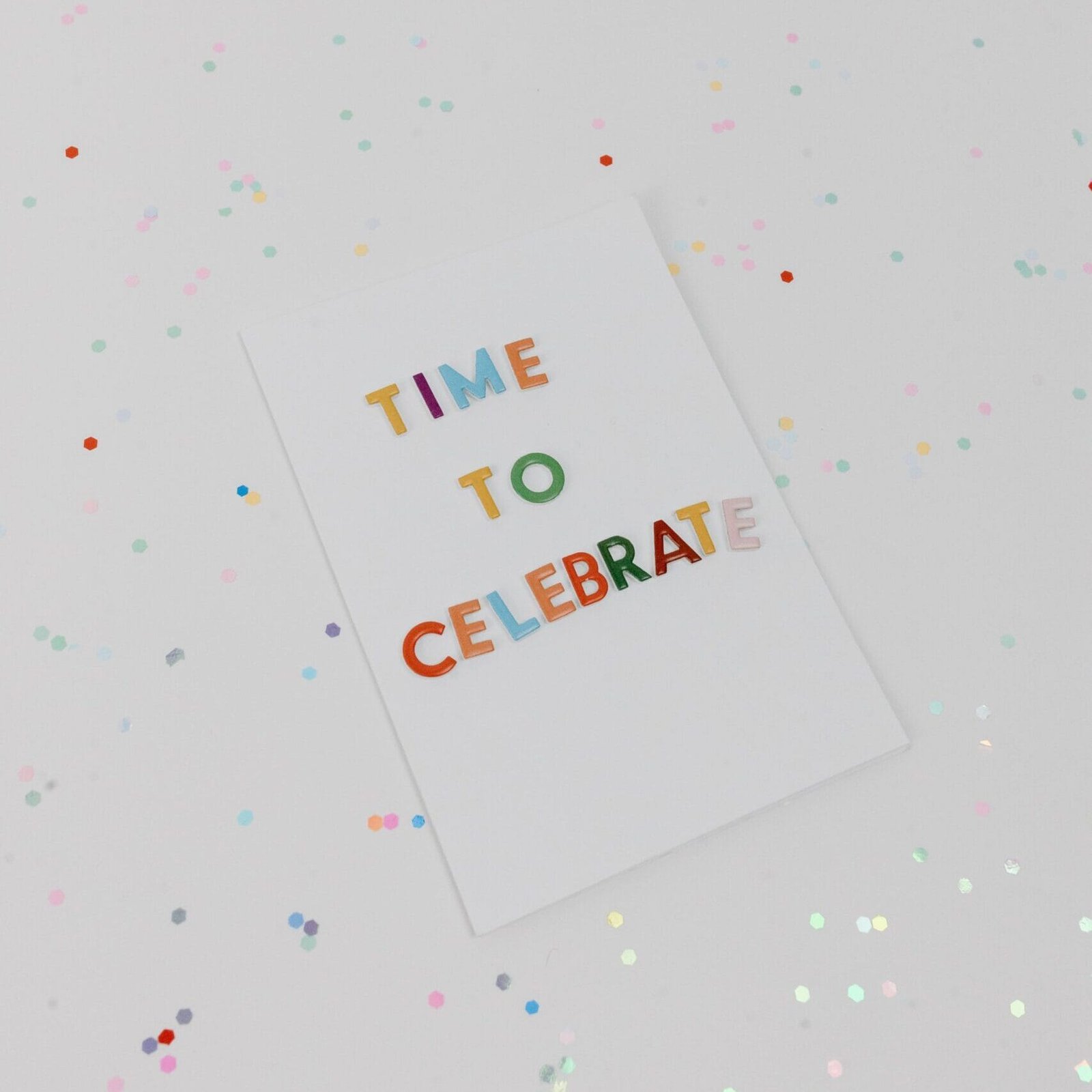 Vibrant 'Time to Celebrate' greeting card surrounded by confetti.
